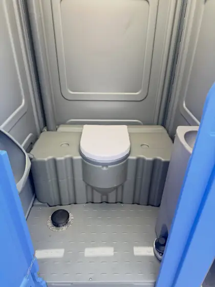 Clean standard porta potty seat and floor